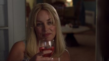 Movie still from “Broken Flowers” (2005), directed by Jim Jarmusch – A woman holding a glass of red wine in her hand; Close Up shot, Over the shoulder angle