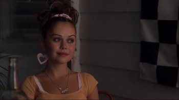 Movie still from “Broken Flowers” (2005), directed by Jim Jarmusch – A woman sitting in front of a building; Close Up shot, Over the shoulder angle