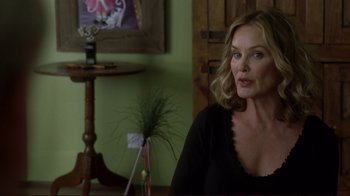 Movie still from “Broken Flowers” (2005), directed by Jim Jarmusch – A woman sitting in front of a wooden table; Close Up shot, Over the shoulder angle
