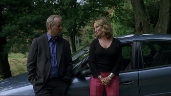 Movie still from “Broken Flowers” (2005), directed by Jim Jarmusch – A man and a woman standing next to each other; Medium shot, Over the shoulder angle