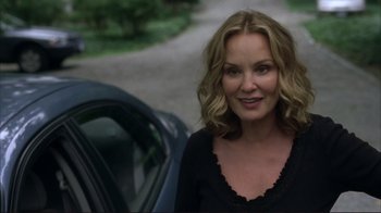 Movie still from “Broken Flowers” (2005), directed by Jim Jarmusch – A woman standing in front of a parked car; Close Up shot, Over the shoulder angle