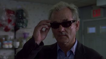 Movie still from “Broken Flowers” (2005), directed by Jim Jarmusch – An older man in a suit and sunglasses adjusts his sunglasses; Close Up shot, Low angle