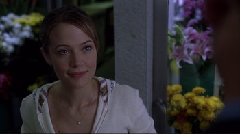 Movie still from “Broken Flowers” (2005), directed by Jim Jarmusch – A beautiful young woman sitting in front of a window; Close Up shot, Over the shoulder angle