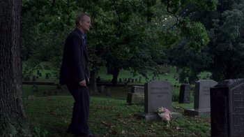 Movie still from “Broken Flowers” (2005), directed by Jim Jarmusch – A man standing next to a grave in a cemetery; Wide shot, Over the shoulder angle