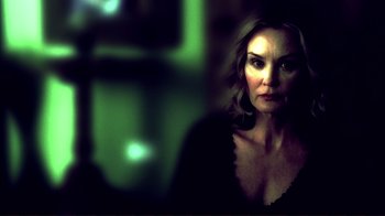 Movie still from “Broken Flowers” (2005), directed by Jim Jarmusch – A woman in a black shirt is looking at the camera; Close Up shot, Low angle