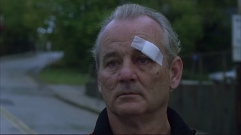 Movie still from “Broken Flowers” (2005), directed by Jim Jarmusch – A man with bandages on his head and a bandage on his eye; Close Up shot, Low angle