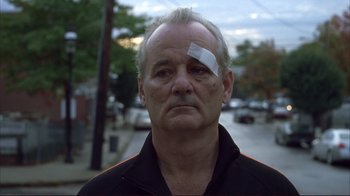 Movie still from “Broken Flowers” (2005), directed by Jim Jarmusch – A man with bandages on his head and a bandage on his face; Close Up shot, Low angle