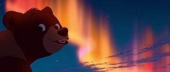Movie still from “Brother Bear” (2003), directed by Robert Walker – A bear is looking up at the sky; Wide shot, Overhead angle