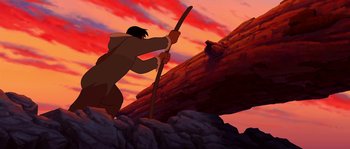 Movie still from “Brother Bear” (2003), directed by Robert Walker – An animated picture of a man holding a stick; Wide shot, Low angle