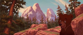 Movie still from “Brother Bear” (2003), directed by Robert Walker – An oil painting of mountains and trees in the background; Wide shot, Low angle