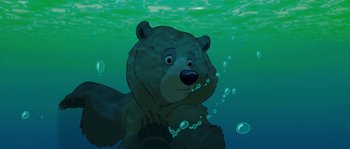 Movie still from “Brother Bear” (2003), directed by Robert Walker – A bear is swimming in the water with bubbles around it; Close Up shot, High angle