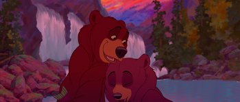 Movie still from “Brother Bear” (2003), directed by Robert Walker – A couple of bears sitting next to each other in front of a waterfall; Wide shot, Overhead angle
