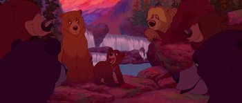 Movie still from “Brother Bear” (2003), directed by Robert Walker – A group of three brown bears sitting on top of a hill; Wide shot, Low angle