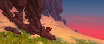 Movie still from “Brother Bear” (2003), directed by Robert Walker – A painting of a brown teddy bear sitting on a cliff; Extreme Wide shot, Low angle