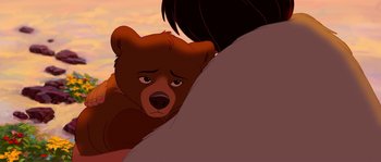 Movie still from “Brother Bear” (2003), directed by Robert Walker – A brown teddy bear sitting on top of a person's arm; Close Up shot, Over the shoulder angle