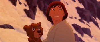 Movie still from “Brother Bear” (2003), directed by Robert Walker – A man holding a teddy bear in front of a mountain; Close Up shot, Low angle