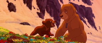 Movie still from “Brother Bear” (2003), directed by Robert Walker – A couple of brown bears standing next to each other on a field; Medium shot, Low angle