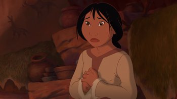 Movie still from “Brother Bear 2” (2006), directed by Ben Gluck – An animated woman with long black hair is praying in a cave; Medium shot, Low angle