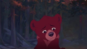Movie still from “Brother Bear 2” (2006), directed by Ben Gluck – A bear sitting in the middle of a forest at night; Medium shot, High angle
