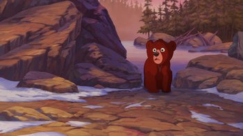 Movie still from “Brother Bear 2” (2006), directed by Ben Gluck – An animated brown bear sitting on a rocky shore; Wide shot, High angle