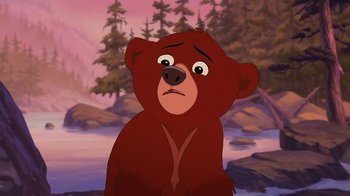 Movie still from “Brother Bear 2” (2006), directed by Ben Gluck – A bear that is standing in front of some trees; Close Up shot, Over the shoulder angle
