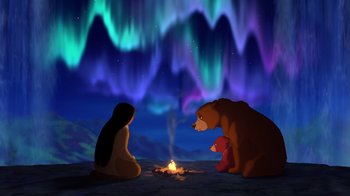 Movie still from “Brother Bear 2” (2006), directed by Ben Gluck – A woman and a bear sitting in front of a campfire; Wide shot, Over the shoulder angle