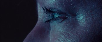 A woman's eye with a blue light shining on it
