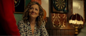 A woman sitting at a table looking up at the ceiling