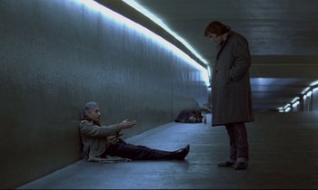 A man sitting on the ground next to a woman
