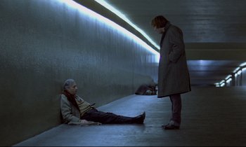 A man and a woman are sitting on the ground