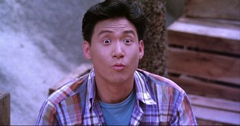 Movie still from “Bullet in the Head” (1990), directed by John Woo – A man with a surprised look on his face; Close Up shot, High angle