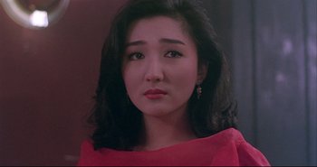 Movie still from “Bullet in the Head” (1990), directed by John Woo – A person wearing a red shirt; Close Up shot, Low angle