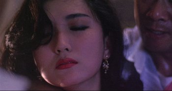 Movie still from “Bullet in the Head” (1990), directed by John Woo – A person wearing a red lipstick; Close Up shot, High angle