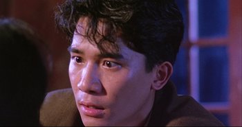 Movie still from “Bullet in the Head” (1990), directed by John Woo – A young man's face; Close Up shot, High angle