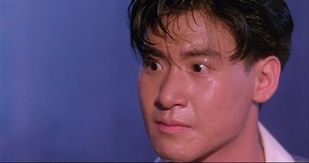 Movie still from “Bullet in the Head” (1990), directed by John Woo – A man's face with water on his face; Close Up shot, Low angle