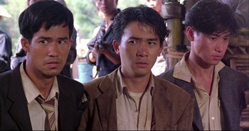 Movie still from “Bullet in the Head” (1990), directed by John Woo – A group of men standing next to each other; Medium shot, High angle
