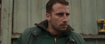 Movie still from “Bullhead” (2011), directed by Michaël R. Roskam – A person wearing a jacket; Close Up shot, Low angle