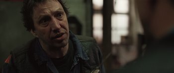 Movie still from “Bullhead” (2011), directed by Michaël R. Roskam – A person wearing a jacket; Close Up shot, Over the shoulder angle