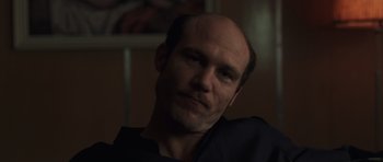 Movie still from “Bullhead” (2011), directed by Michaël R. Roskam – A man with a bald head is looking at the camera; Close Up shot, Low angle