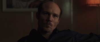 Movie still from “Bullhead” (2011), directed by Michaël R. Roskam – A man with a bald head is looking at the camera; Close Up shot, Low angle