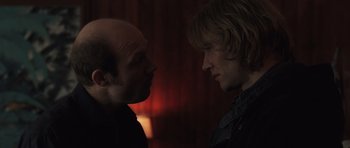 Movie still from “Bullhead” (2011), directed by Michaël R. Roskam – Two men facing each other in a dark room; Close Up shot, Over the shoulder angle