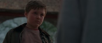 Movie still from “Bullhead” (2011), directed by Michaël R. Roskam – A young boy wearing a leather jacket looking at the camera; Close Up shot, Low angle