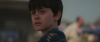 Movie still from “Bullhead” (2011), directed by Michaël R. Roskam – A young boy is looking into the distance; Close Up shot, Over the shoulder angle