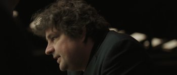 Movie still from “Bullhead” (2011), directed by Michaël R. Roskam – A person with curly hair; Close Up shot, Low angle