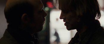 Movie still from “Bullhead” (2011), directed by Michaël R. Roskam – Two people face to face in a dark room; Close Up shot, Over the shoulder angle