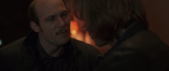 Movie still from “Bullhead” (2011), directed by Michaël R. Roskam – A man and a woman are looking at one another; Close Up shot, Over the shoulder angle