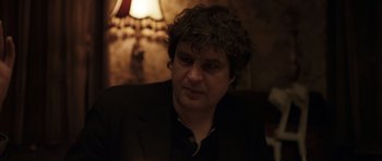 Movie still from “Bullhead” (2011), directed by Michaël R. Roskam – A person wearing a suit and tie; Close Up shot, Over the shoulder angle