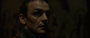 Movie still from “Bullhead” (2011), directed by Michaël R. Roskam – A man's face in the dark; Close Up shot, Low angle