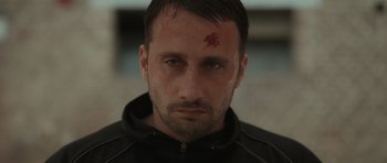 Movie still from “Bullhead” (2011), directed by Michaël R. Roskam – A person with a blood spot on his forehead; Close Up shot, Low angle