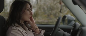 Movie still from “Bullhead” (2011), directed by Michaël R. Roskam – A woman sitting in the driver's seat of a car; Close Up shot, Low angle